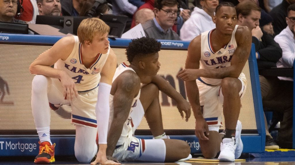 Kansas freshman guard Gradey Dick (4), sophomore forward KJ Adams Jr. (24) and freshman guard MJ Rice (11) wait to be transitioned in to play during the first half of Friday's game against Southern Utah inside Allen Fieldhouse.