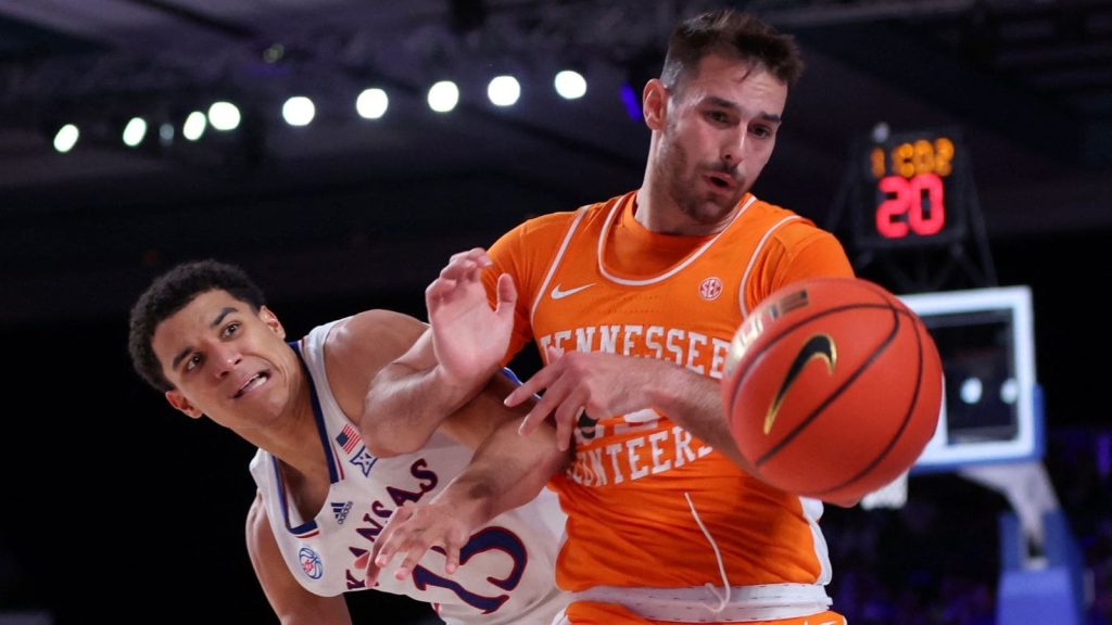 Nov 25, 2022; Paradise Island, BAHAMAS; Tennessee Volunteers guard Santiago Vescovi (25) and Kansas Jayhawks guard Kevin McCullar Jr. (15) go for a loose ball during the second half at Imperial Arena. Mandatory Credit: Kevin Jairaj-USA TODAY Sports