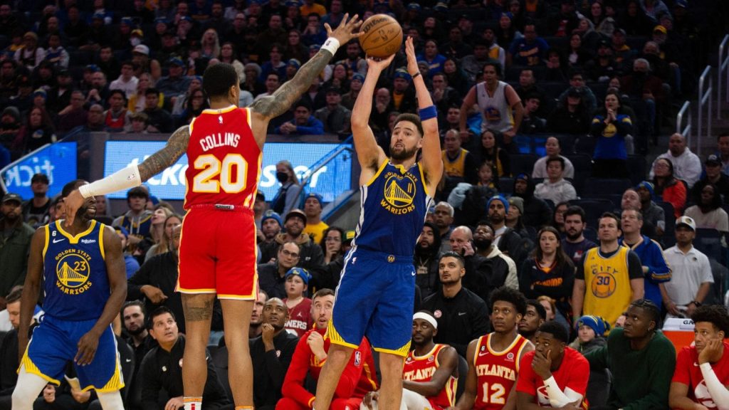 Jan 2, 2023; San Francisco, California, USA; Golden State Warriors guard Klay Thompson (11) shoots over Atlanta Hawks forward John Collins (20) during the first overtime at Chase Center. Mandatory Credit: D. Ross Cameron-USA TODAY Sports